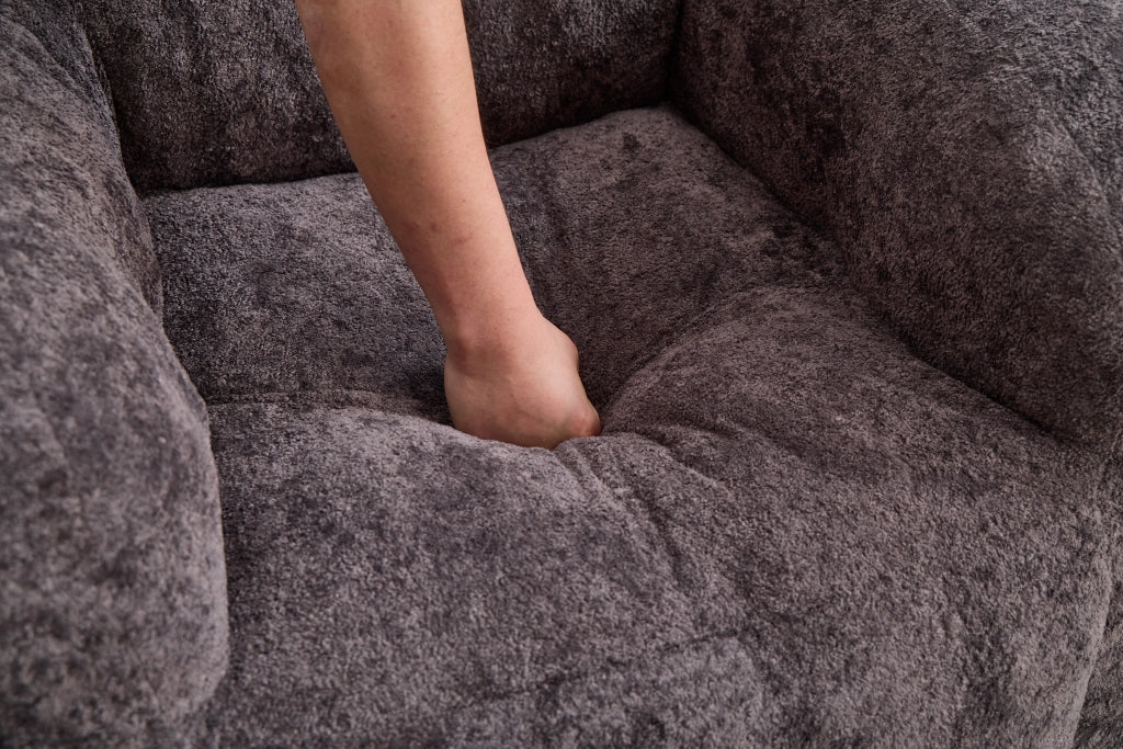 Pouf con imbottitura in schiuma sminuzzata e schienale ergonomico con braccioli, in pelliccia sintetica, grigio scuro