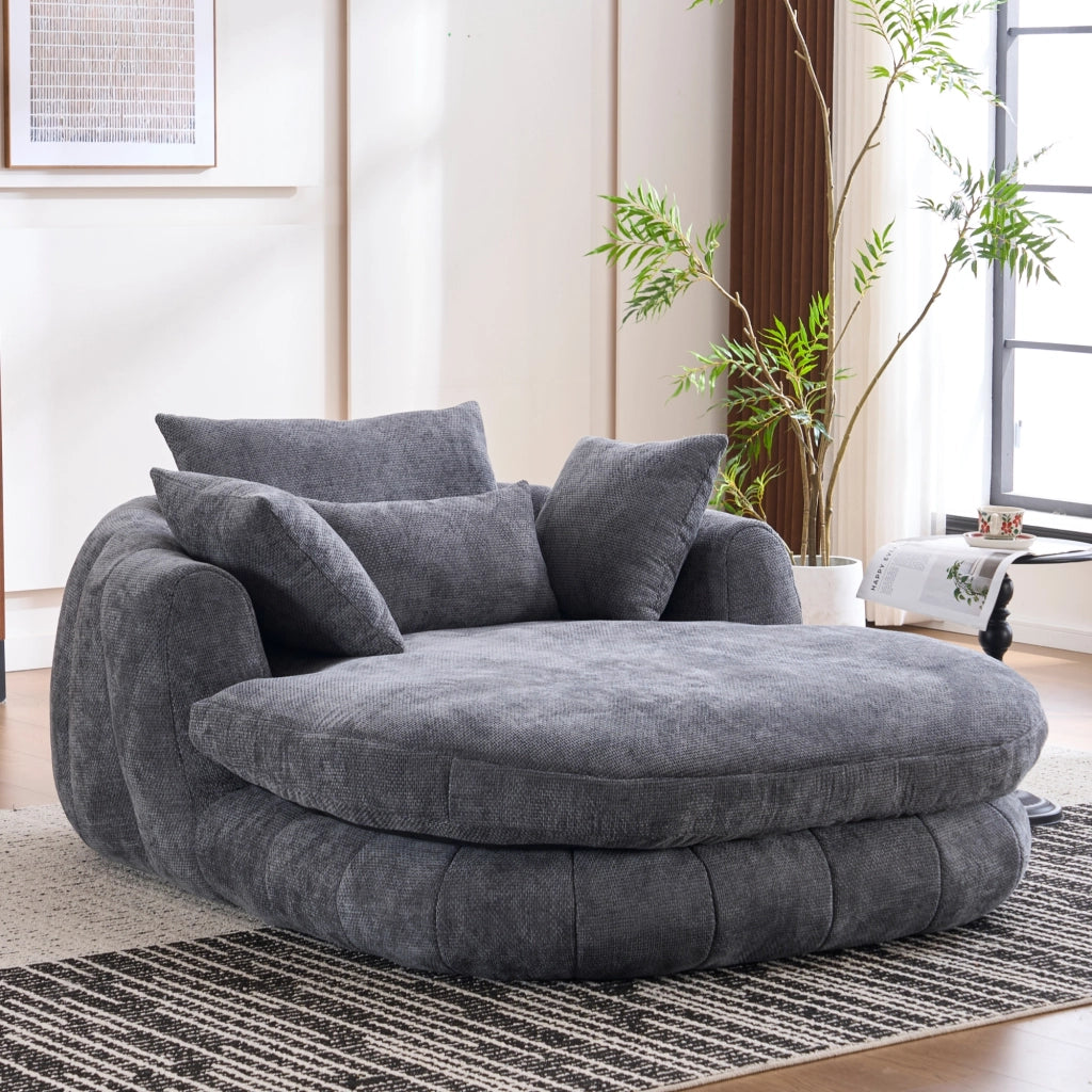 Poltrona chaise longue in ciniglia grigia con seduta profonda e cuscini