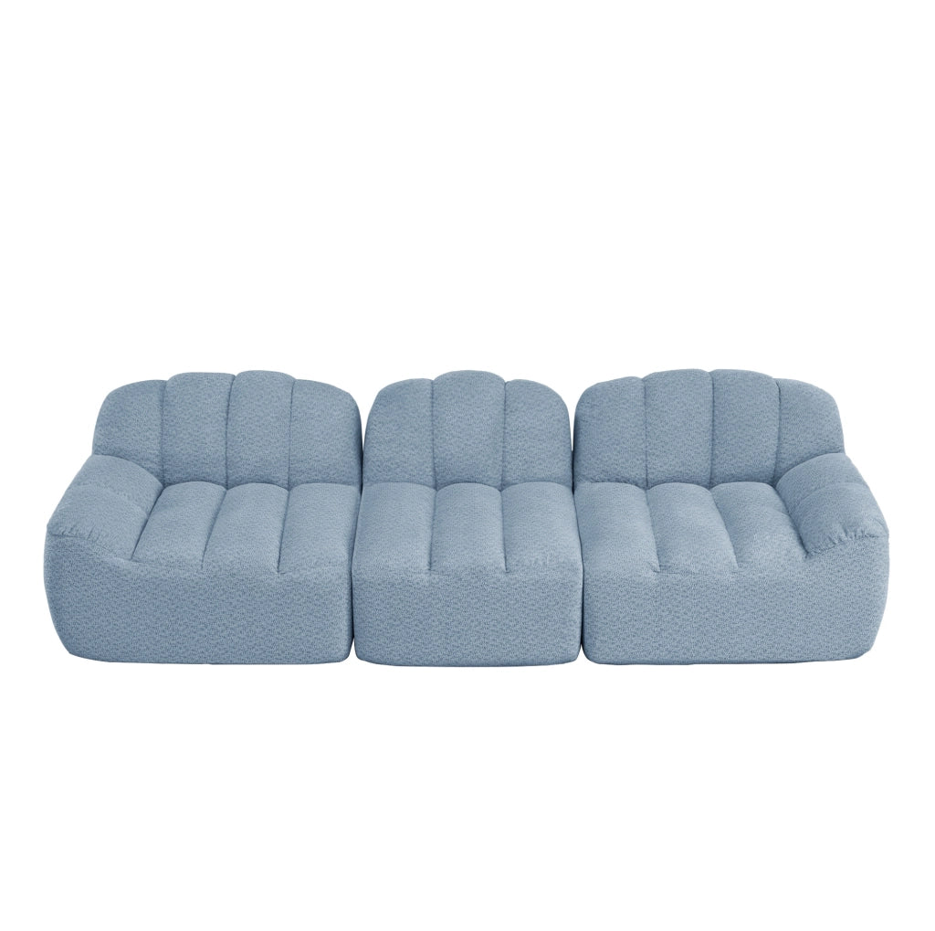 Divano modulare ad angolo in fleece granulare blu; design senza struttura e seduta ampia