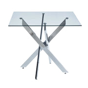 Tavolo da pranzo con piano in vetro e gambe incrociate in metallo; design moderno per cucina e soggiorno; Argento