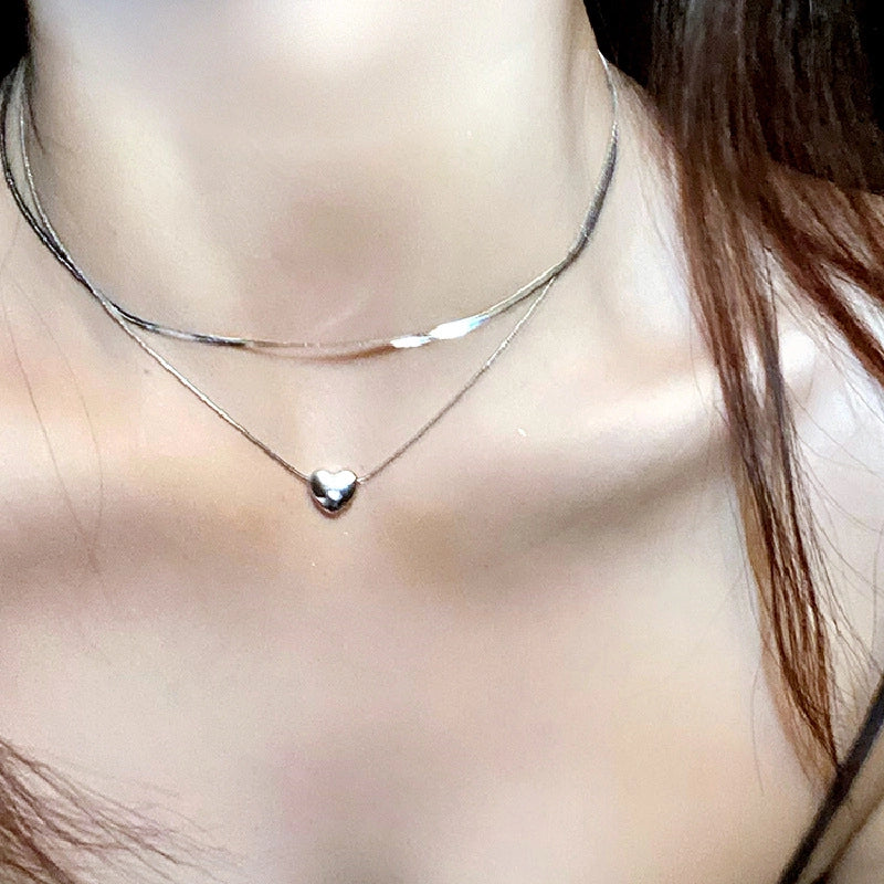 Collana minimalista a forma di cuore in acciaio al titanio con catena a osso di serpente.