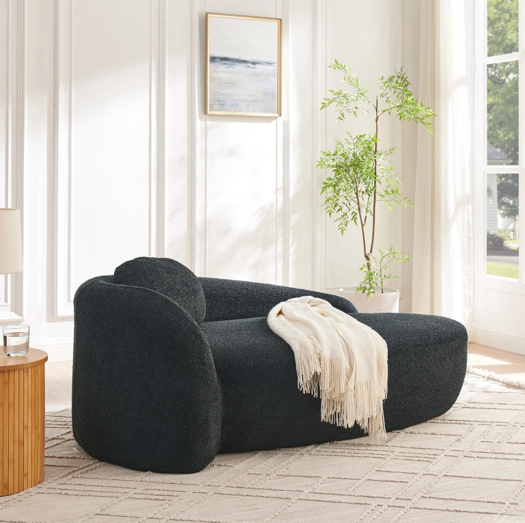 Divano minimalista in tessuto Teddy nero, compatto e confortevole