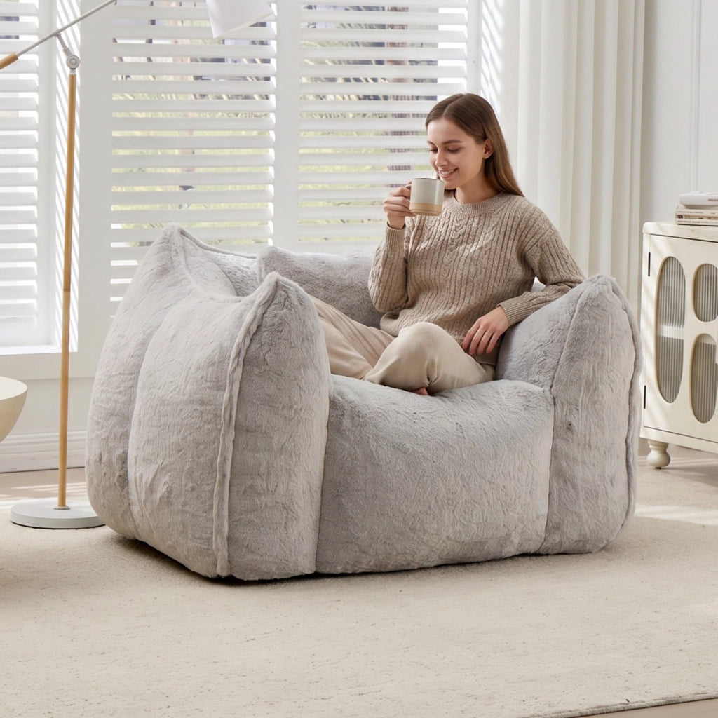 Poltrona pouf con schienale ergonomico e imbottitura in schiuma, in pelliccia sintetica grigia per soggiorno