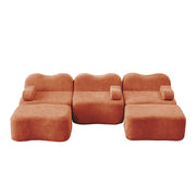 Divano modulare a U senza struttura; seduta profonda; con pouf; in velluto arancione