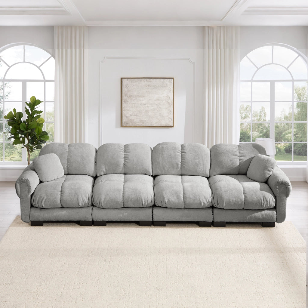 Divano modulare 4 posti con cuciture trapuntate e cuscino lombare in chenille grigio chiaro