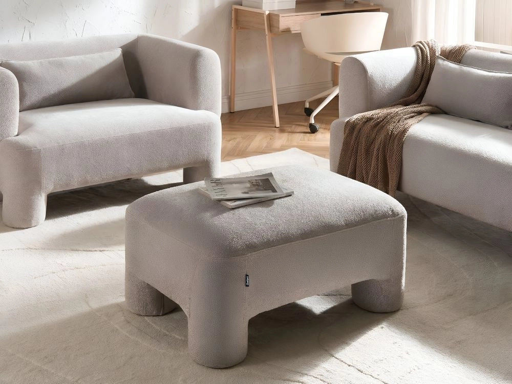 Ottomana in tessuto beige scuro con rivestimento in peluche, gambe cilindriche e stile organico