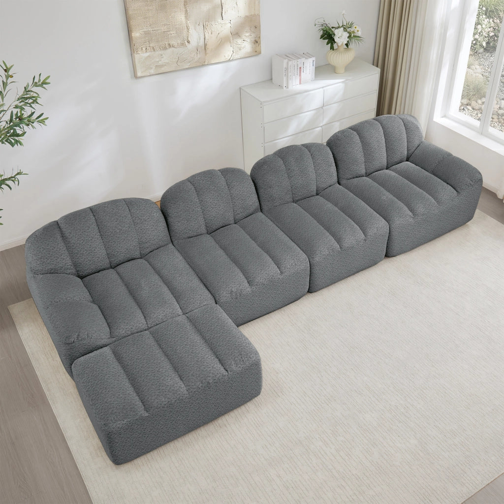 Divano modulare 4 posti con ottomana; forma curva; schiuma 32D; tessuto pile granigliato grigio