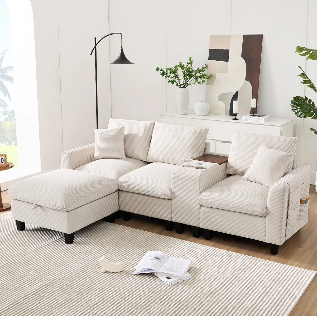 Divano angolare 229x149.5x83 cm con console centrale; porte USB e tasche portaoggetti in corduroy beige