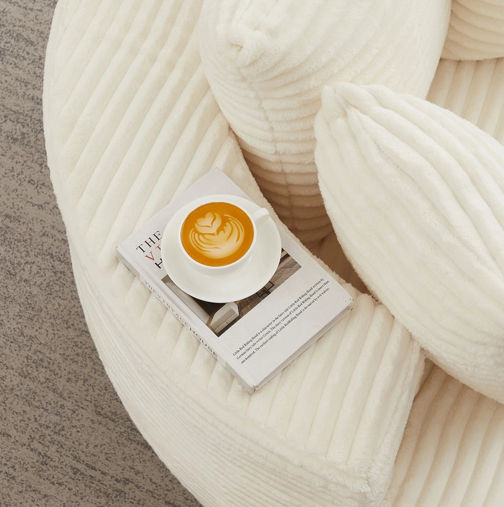 Poltrona relax rotonda in velluto a coste beige con tre cuscini