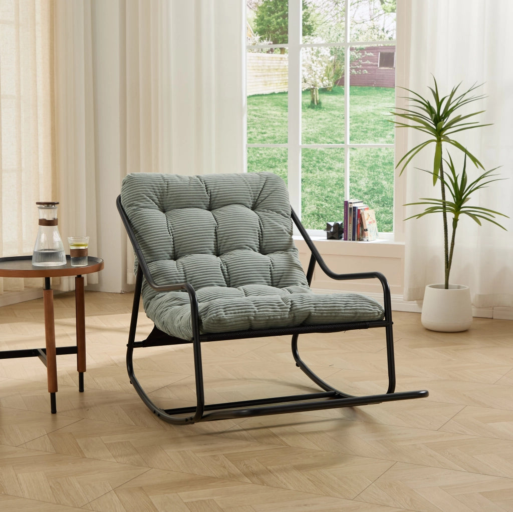 Poltrona a dondolo con pouf, struttura nera e cuscino verde chiaro