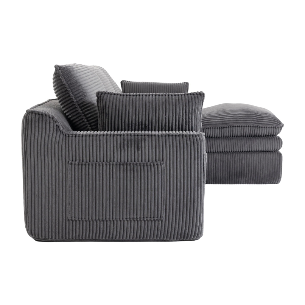 Divano modulare in corduroy grigio scuro con cuscini, tasche laterali e poggiapiedi