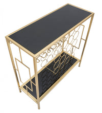 Console in metallo dorato, con piani in vetro temprato, colore nero, dalle linee regolari e geometriche, Misure 30 x 75 x 76 cm