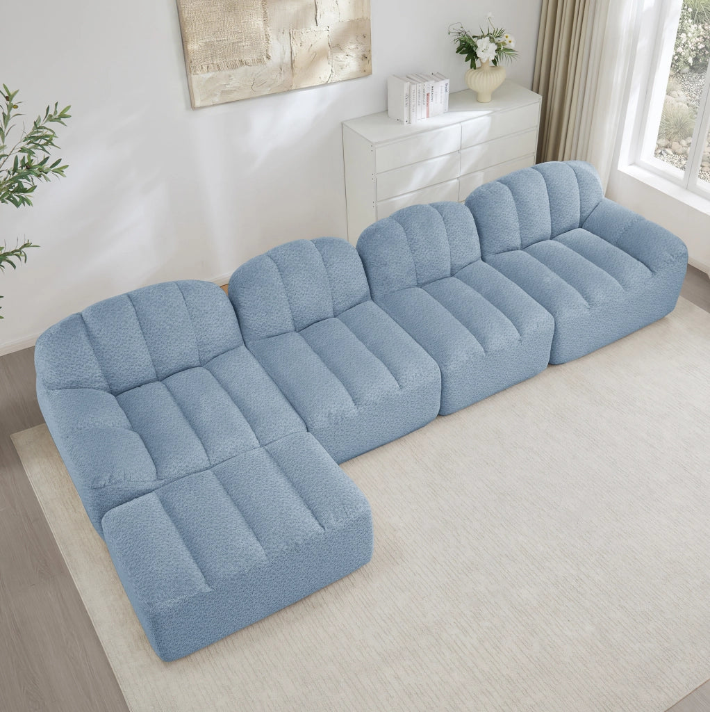 Divano modulare 4 posti con ottomana; design senza struttura in fleece granulato blu