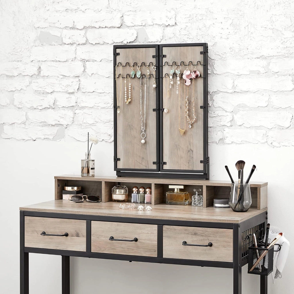 VASAGLE Tavolo da toilette con specchio pieghevole in 3 pezzi, supporto per asciugacapelli, tavolo cosmetico con sgabello imbottito, 3 cassetti, design industriale, Greige e nero RVT004B02