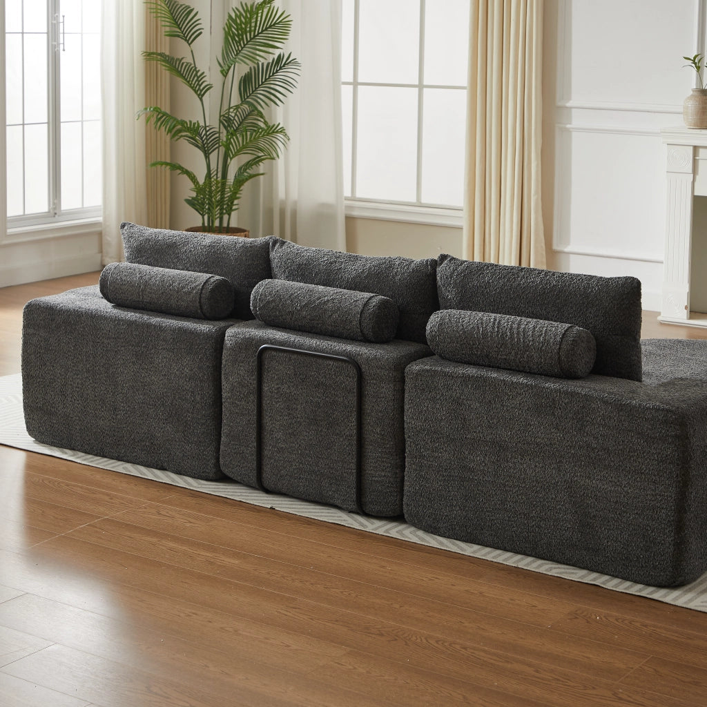 Divano componibile a L con chaise longue in chenille grigio con cuscini, supporto in ferro e moduli reversibili