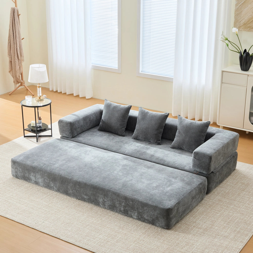 divano modulare trasformabile con tasche laterali; base antiscivolo e chiusura con zip in ciniglia grigio scuro