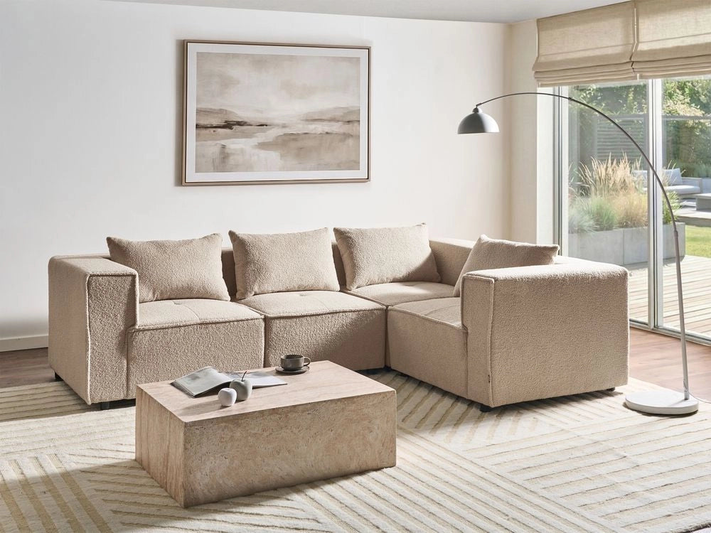 Divano a 4 posti in tessuto bouclè modulare beige lato sinistro stile minimale moderno