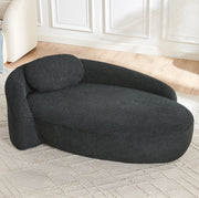 Divano minimalista in Teddy nero; morbido con cuscino testa; design arrotondato