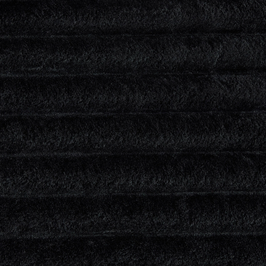Divano in tessuto corduroy nero con schienale alto, tasche laterali, portabicchieri e funzione letto