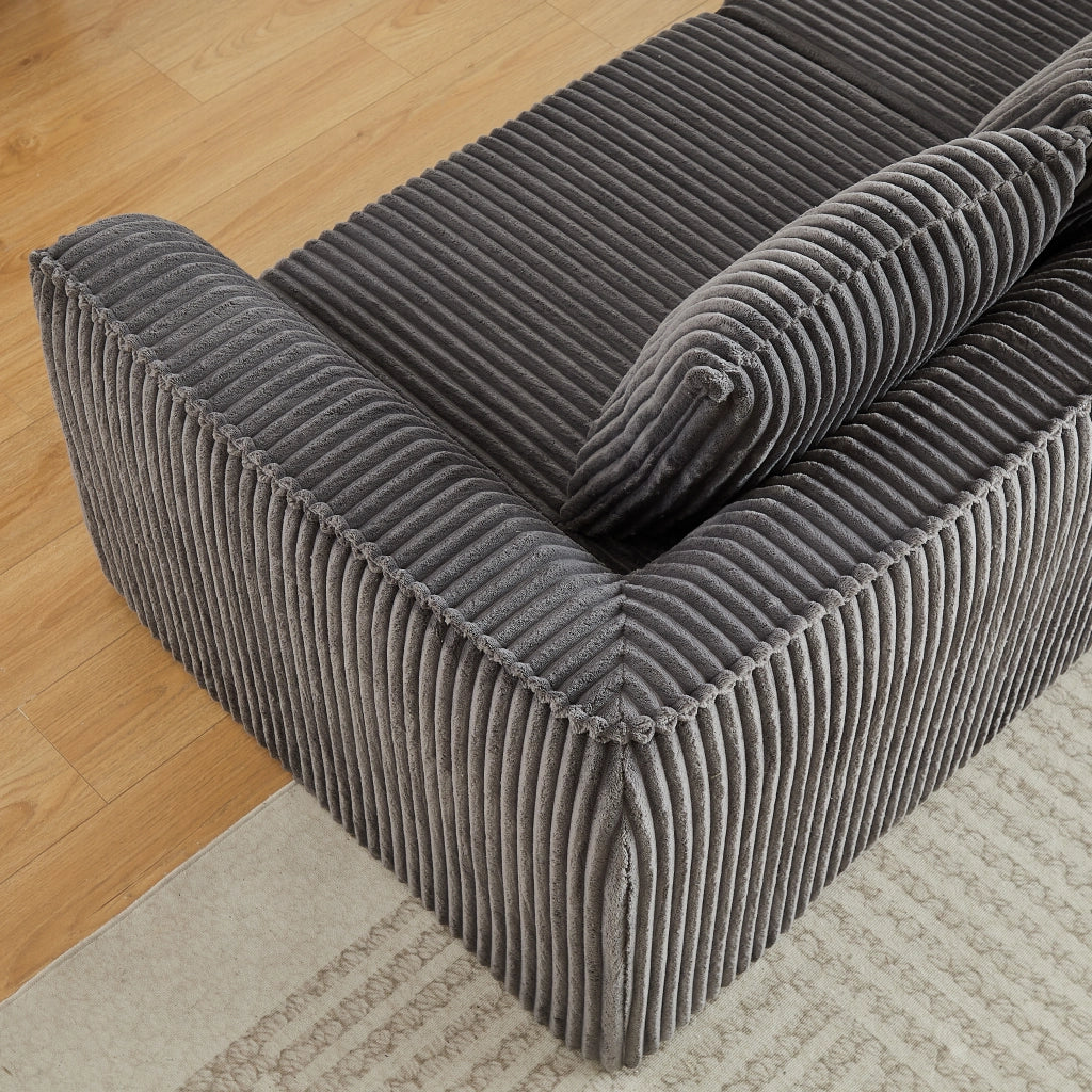 Divano modulare in velluto a coste con linee sinuose e seduta ampia, per soggiorno e relax quotidiano, grigio