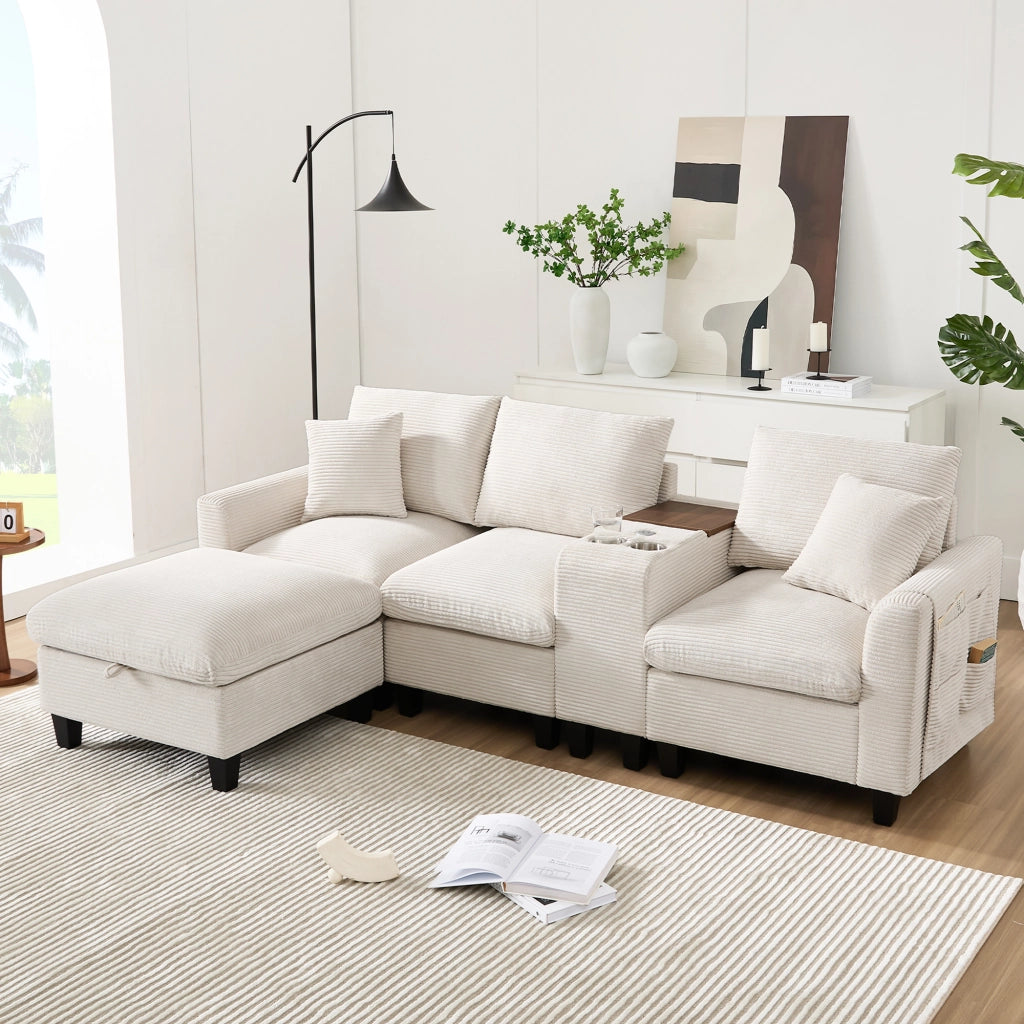 Divano angolare modulare con console centrale USB portabicchieri tasche laterali e cuscini in velluto a coste beige