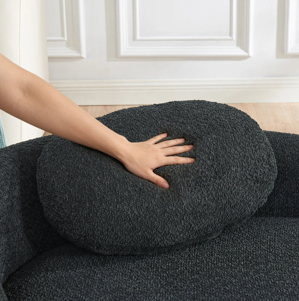 Divano minimalista in tessuto Teddy nero, compatto e confortevole