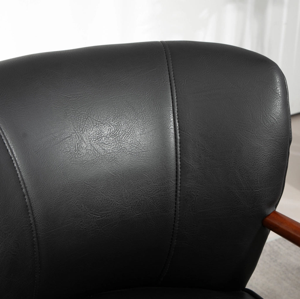 Poltroncina imbottita nera con braccioli e gambe in legno