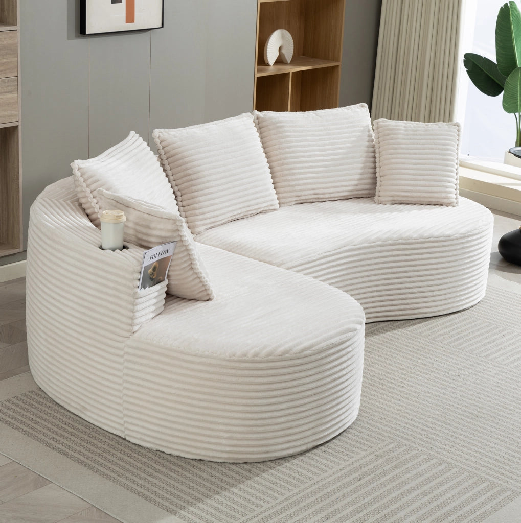 Divano curvo in velluto a coste beige con portabevande
