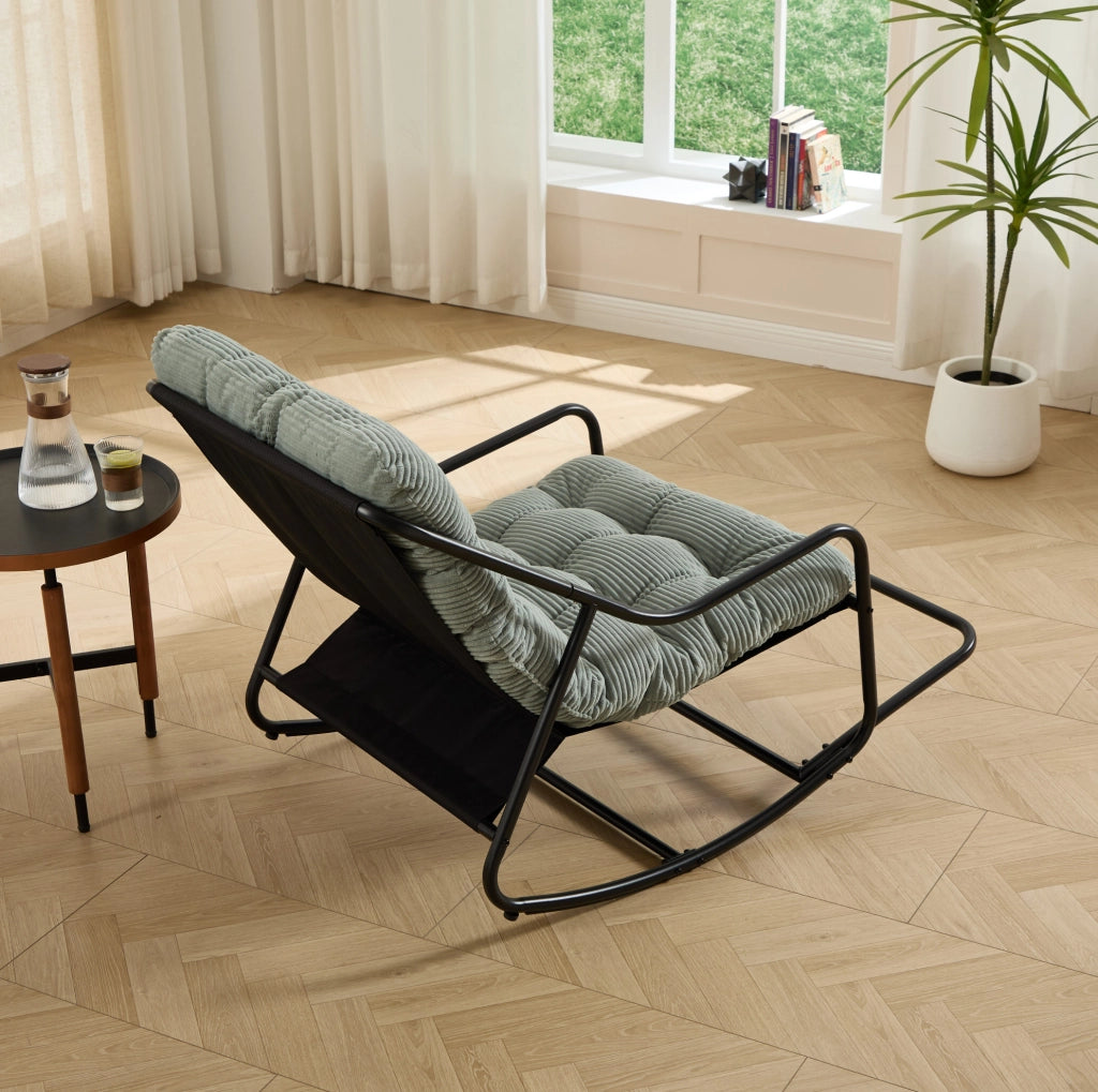 Poltrona a dondolo con pouf, struttura nera e cuscino verde chiaro