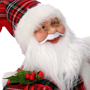 Babbo natale in tessuto rosso seduto con regali, musica e movimento cm xh35,5