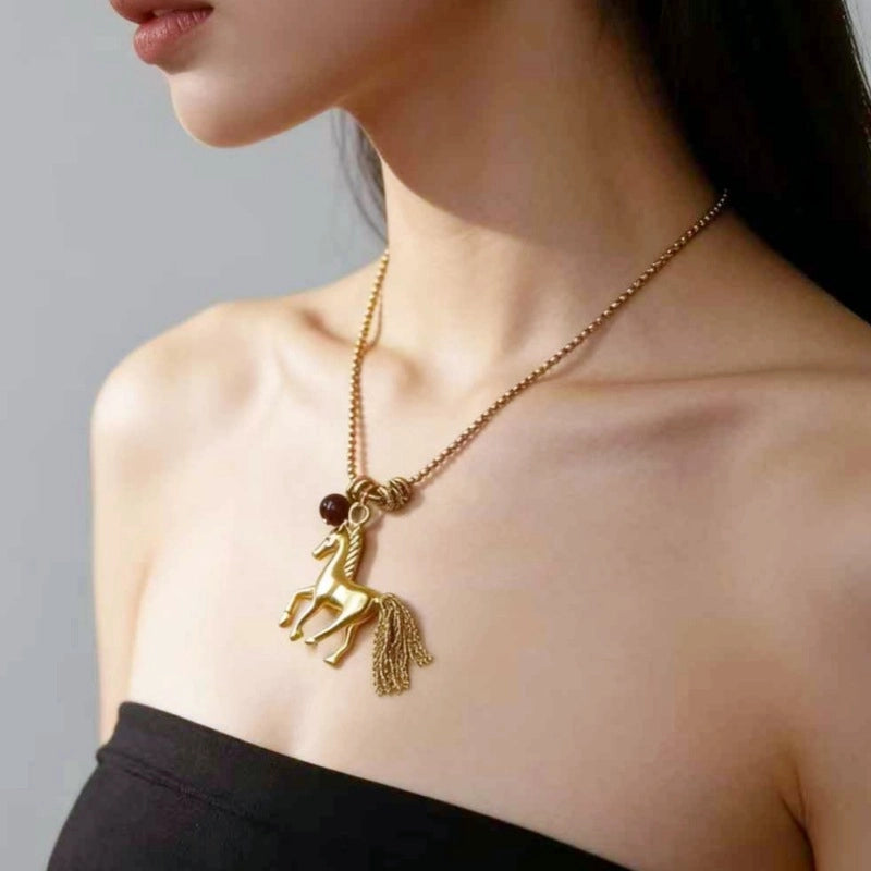 Collana lunga vintage con ciondolo a forma di pony e catena in metallo.