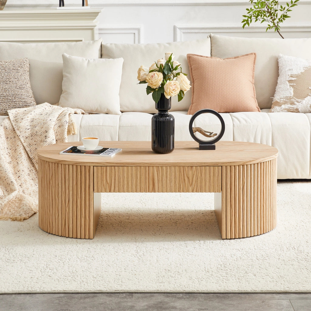 Tavolino basso ovale con cassetto e vano aperto frontali zigrinati in MDF effetto rovere chiaro per soggiorno 118 × 65 × 17 cm