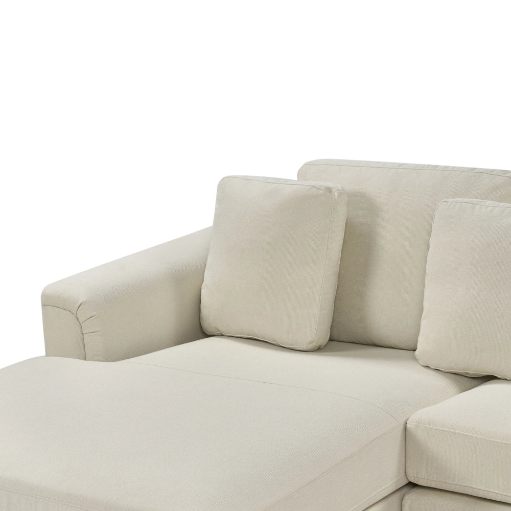 Divano ad angolo rivestito in tessuto beige a forma di L con orientamento a versione destra