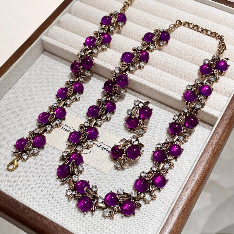 Collana, bracciale e orecchini a forma di foglia in resina viola con strass, in stile vintage.
