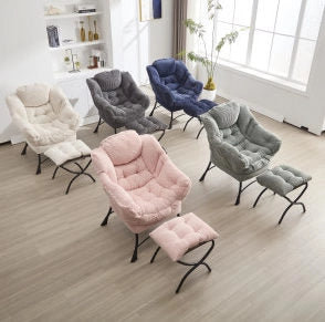 Poltrona lounge rosa con poggiapiedi e tasca laterale