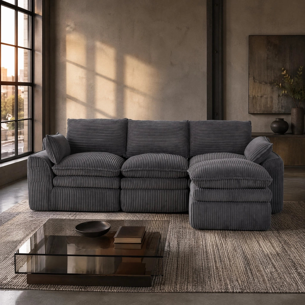 Divano modulare in corduroy grigio scuro con cuscini, tasche laterali e poggiapiedi