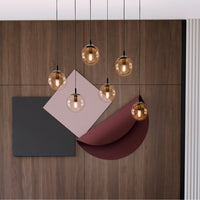 Sospensione Moderna 6 Luci Kali In Acciaio Nero E Sfere In Vetro Ambra