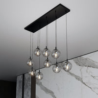 Sospensione Moderna 9 Luci Kali In Acciaio Nero E Sfere In Vetro Fumè