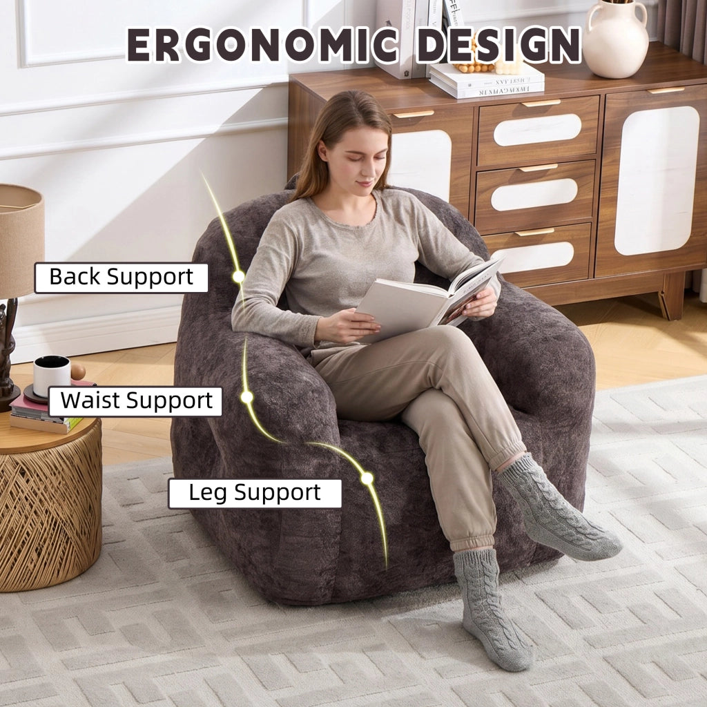 Pouf con imbottitura in schiuma sminuzzata e schienale ergonomico con braccioli, in pelliccia sintetica, grigio scuro