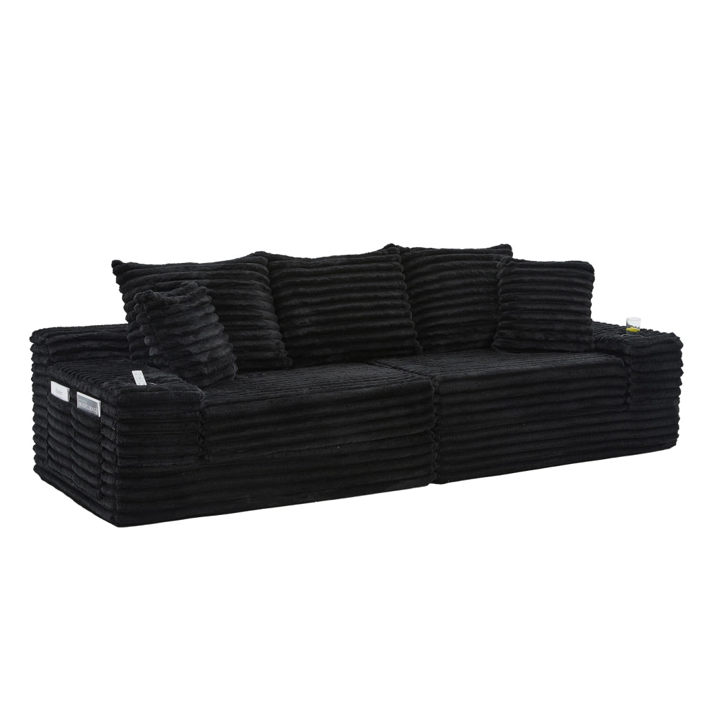 Divano in tessuto corduroy nero con schienale alto, tasche laterali, portabicchieri e funzione letto