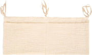 Organizzatore per lettini con contenitore per oggetti e coprisacco per bambini in beige.