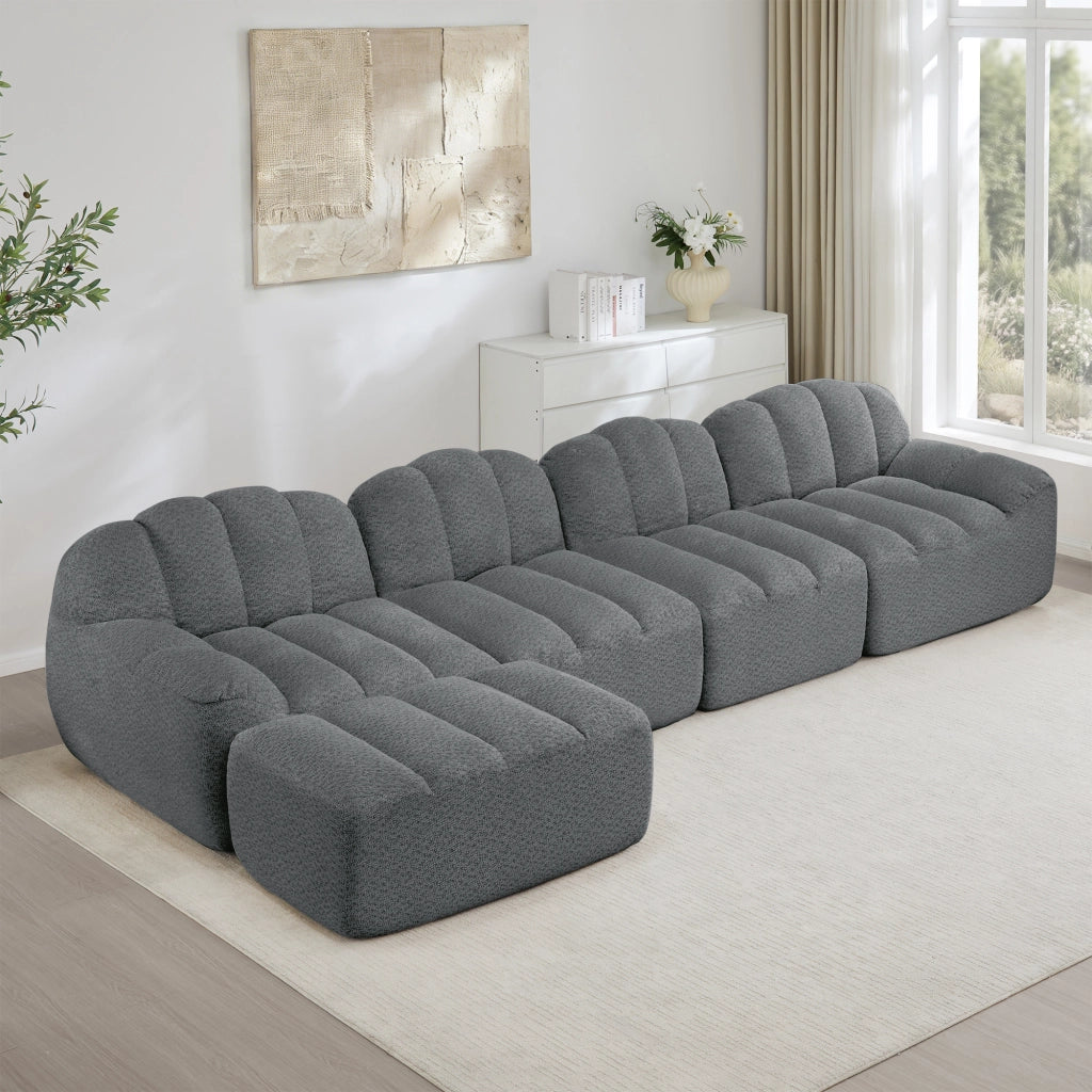 Divano modulare 4 posti con ottomana; forma curva; schiuma 32D; tessuto pile granigliato grigio