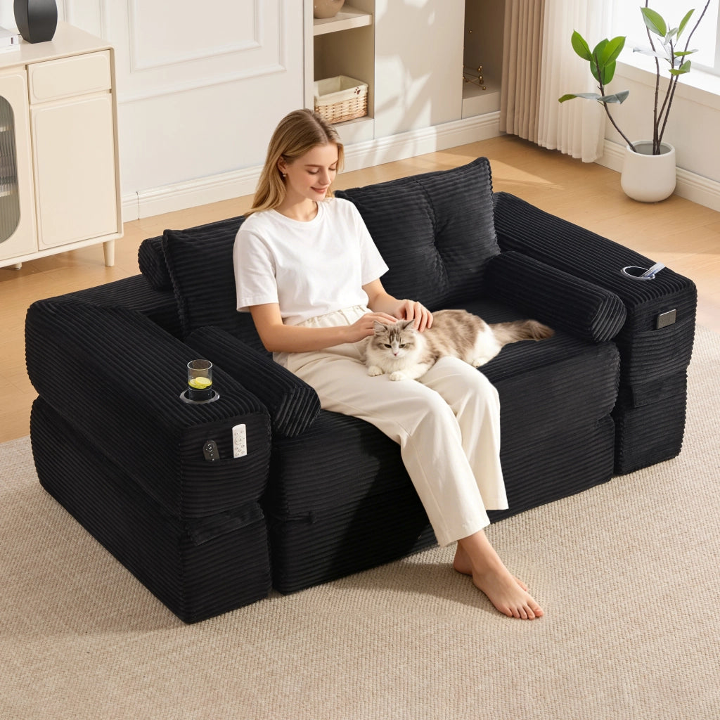 Divano convertibile 2 posti in corduroy con cuscini memory, tasche laterali e portabicchieri nero