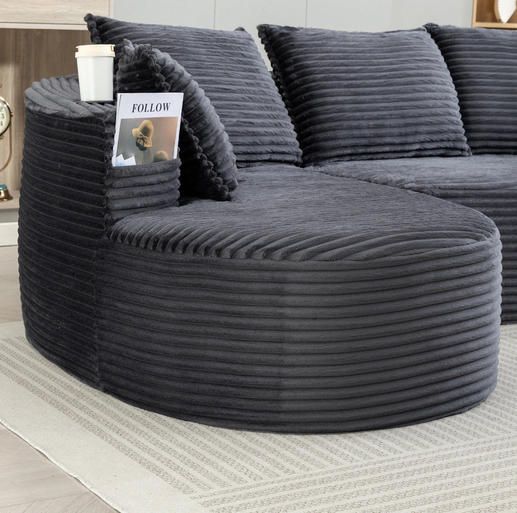 Divano curvo in corduroy grigio scuro con portabicchieri
