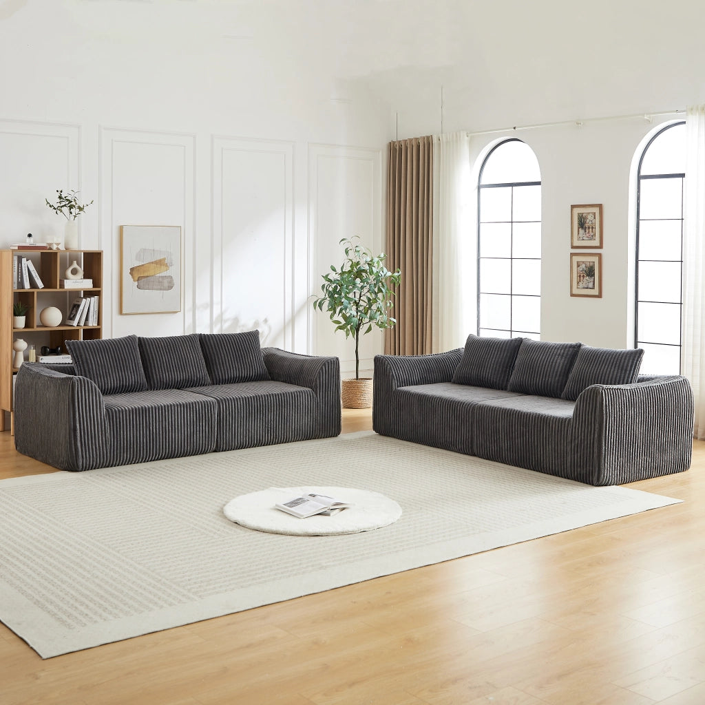 Divano modulare in velluto a coste con linee sinuose e seduta ampia, per soggiorno e relax quotidiano, grigio