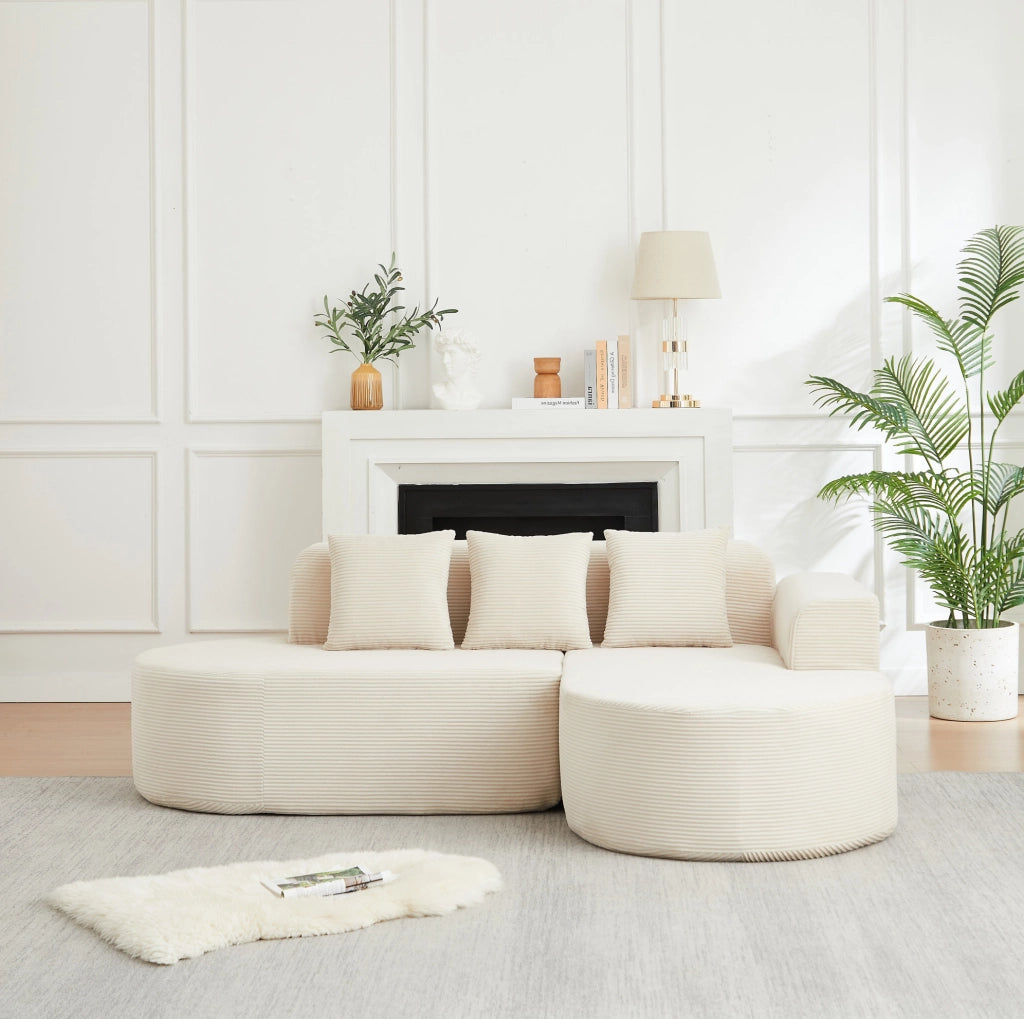Divano modulare a L beige in velluto a coste con forme curve