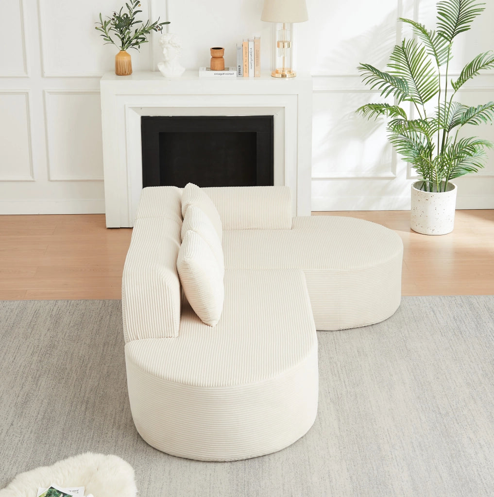 Divano modulare a L beige in velluto a coste con forme curve