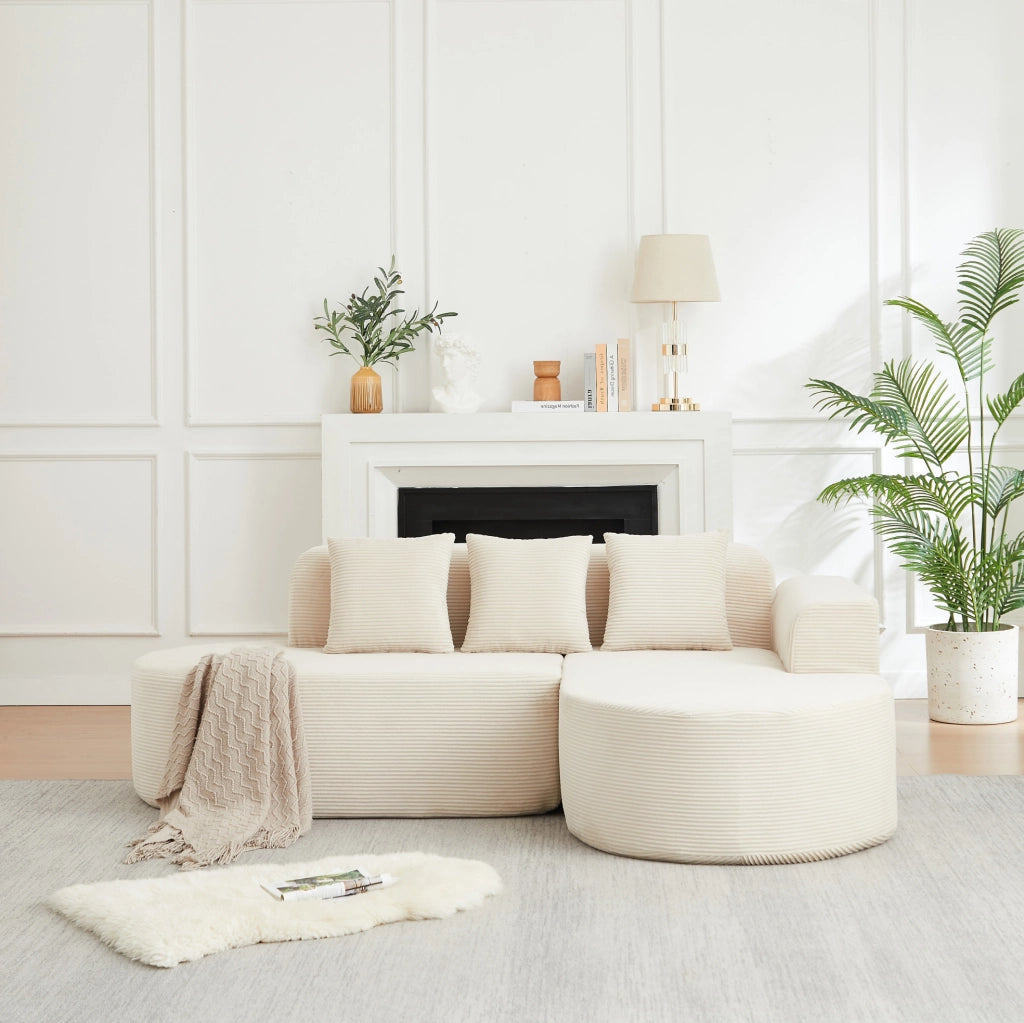 Divano modulare a L beige in velluto a coste con forme curve