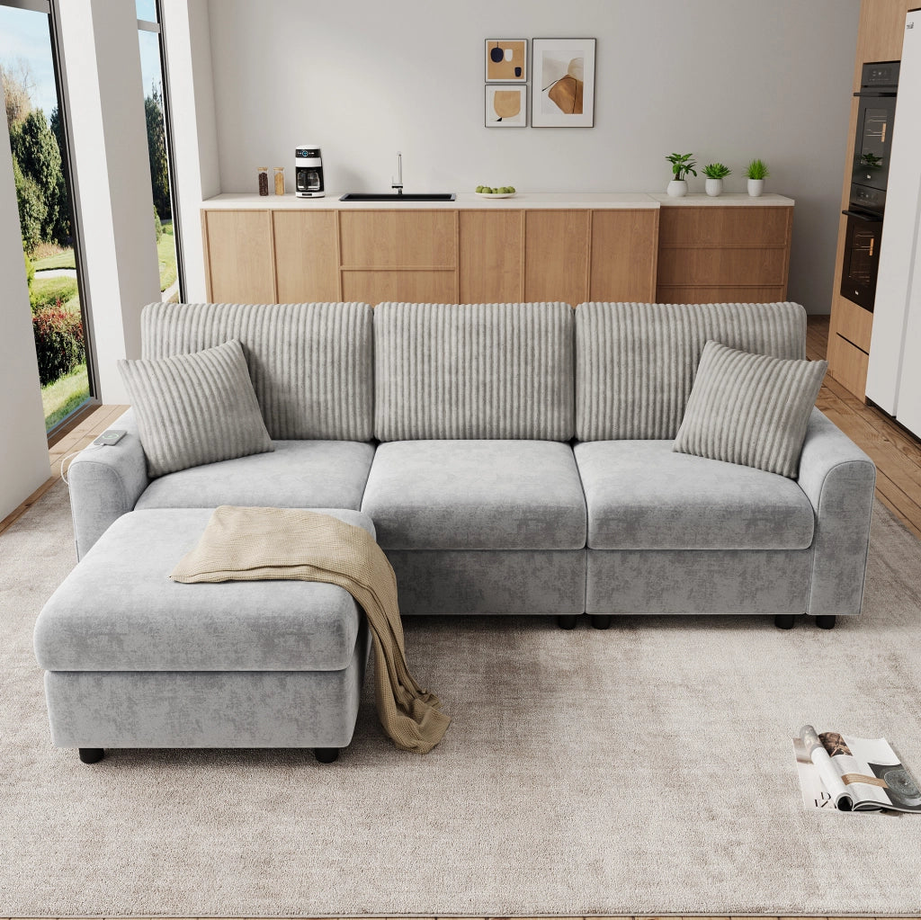 Divano grigio 223x146 cm con pouf, 2 cuscini, USB e USB-C in ciniglia e velluto a coste