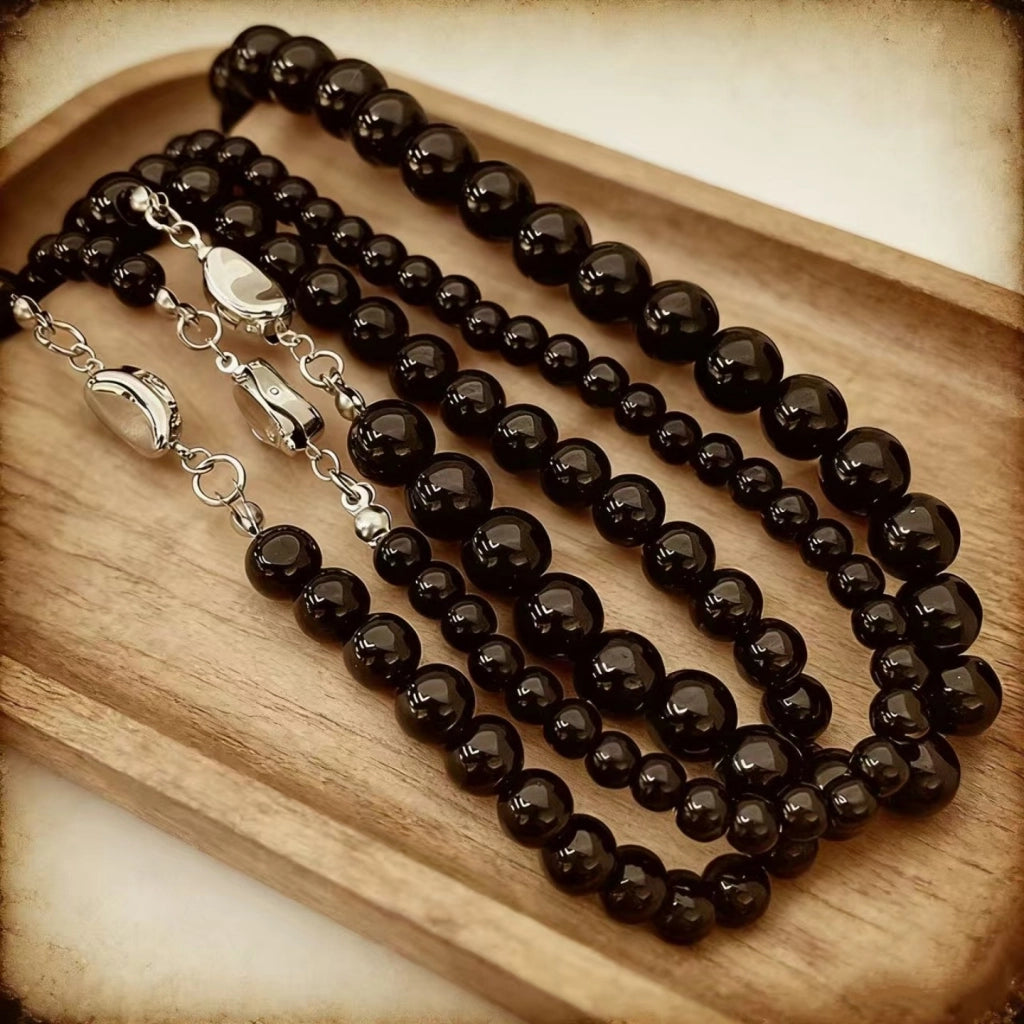 Nuova collana rotonda con perline nere e chiusura a lingotto.